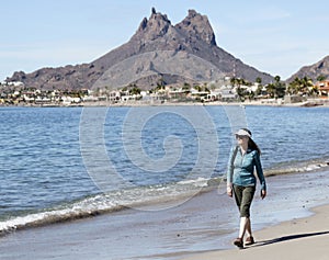 A Woman Walks the Beach, Tetakawi Mountain Behind, San Carlos, M photo
