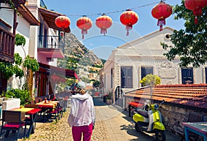 Woman walks down the picturesque street of Kalkan in Turkey