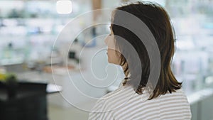 A woman walks through an electronics store and chooses her purchases. Modern smart gadgets in a big store