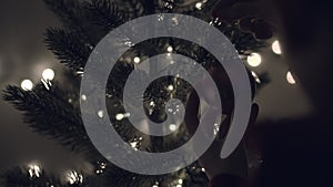 A woman walks holding christmas balls to decorate the christmas tree