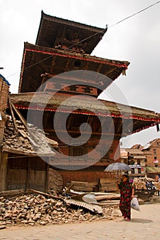 A woman walks outside a temple in Bhaktapur, Nepal