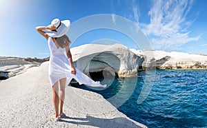 Woman walks on Sarakiniko, on the island of Milos, Cyclades, Greece