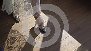 Woman walks in white women's shoes with high heels. Shoes for bride.