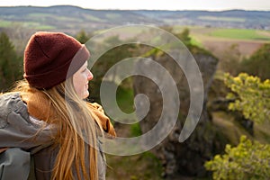 Woman wanderer enjoys view above valley