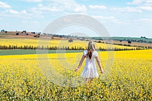 Woman wanders in fields of flowers