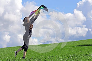 A woman wants to fly a kite in autumn