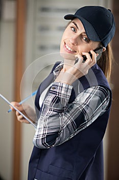 woman warehouse worker or supervisor with smartphone