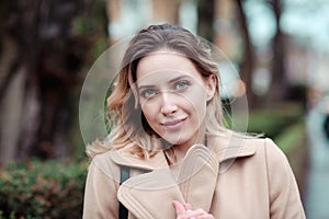 Woman with warm clothes looking at you camera