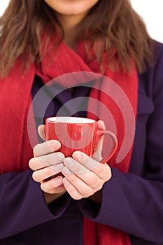 Woman in warm clothing holding mug