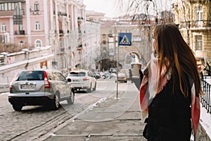 Woman in warm clothing standing in city street during winter