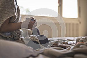 Woman in warm cosy clothes drinking hot drink