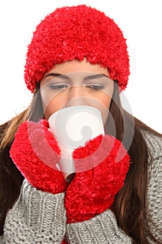 Woman in warm festive woolly hat with hot drink