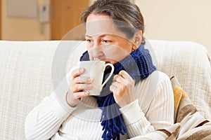 Woman in warm scarf with hot cup