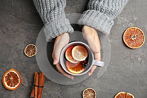 Woman in warm sweater with cup