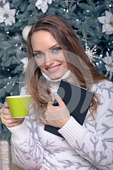 Woman in a warm sweater with a cup of tea