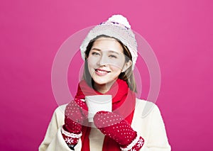 Woman in warm sweater drinking a cup of tea