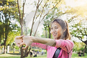 Woman warm up her body by stretching her arms to be ready for exercising.