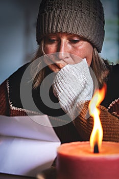 Woman with warm winter clothes is is reading