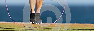 Woman warming up with jump rope outdoors