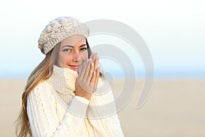Woman warmly clothed in winter on the beach photo