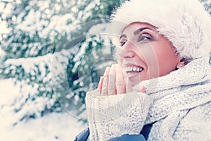 Woman warms her fingers with breathing photo