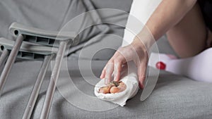 a woman warms up numb toes in plaster