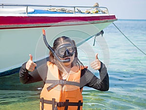 Woman warring snorkler on summer vacation