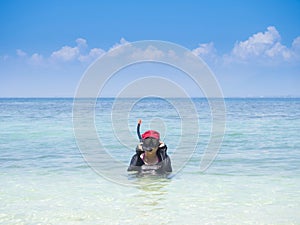 Woman warring snorkler on summer vacation