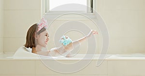 Woman wash body in bathtub