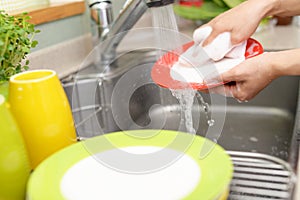 Woman wash the dishes