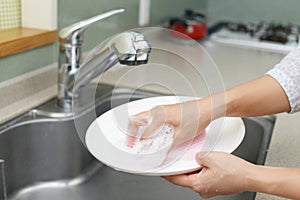 Woman wash the dishes
