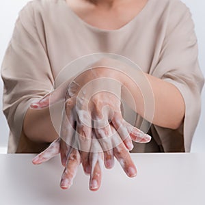 Woman wash hands on white background