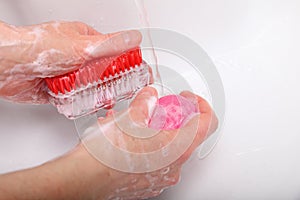 Woman wash soapy hands in bathroom