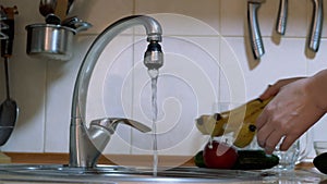 Woman Washes Fruit, Vegetables in Sink under a Stream of Flowing Water. 4K