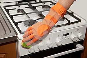 Woman washes the gas-stove