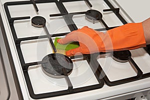 Woman washes the gas-stove