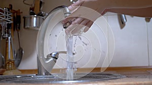 Woman Washes Hands under a Strong Stream of Running Water, Closes Tap. Leak.