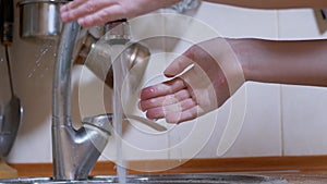 Woman Washes Hands under a Strong Stream of Running Water, Closes Tap. Leak. 4K