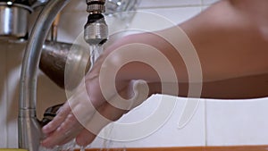 Woman Washes Hands under a Strong Stream of Running Water, Turns off Tap. Splash