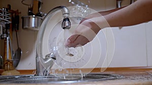 Woman Washes Hands under a Strong Stream of Running Water, Turns off Tap. Splash