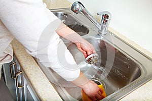 Woman washes the sink