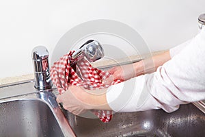 Woman washes the sink