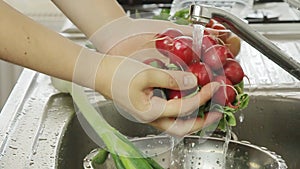 Woman washin vegetables