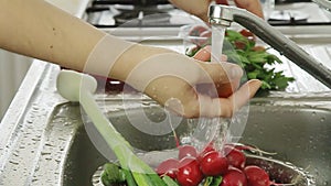 Woman washin vegetables