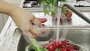 Woman washin vegetables