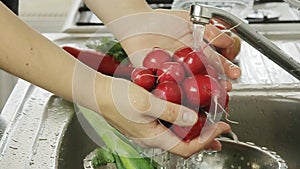 Woman washin vegetables