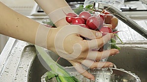 Woman washin vegetables