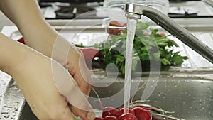 Woman washin vegetables