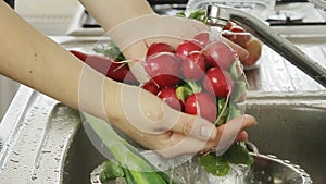 Woman washin vegetables