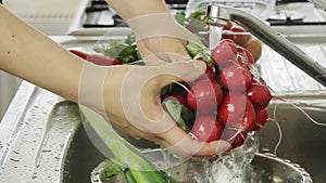 Woman washin vegetables